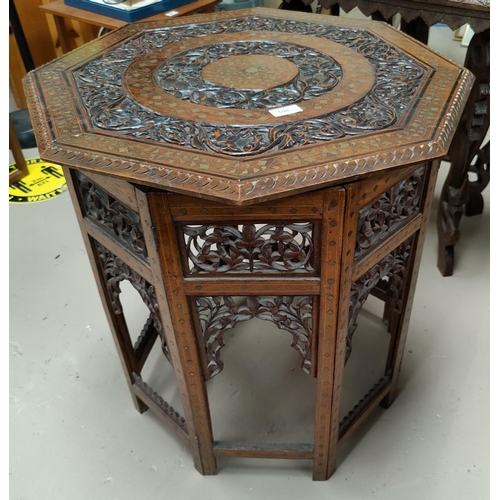 598 - A Far Eastern occasional table with brass inlaid octagonal top