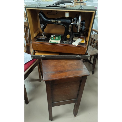 602 - A 1930's oak workbox; a Singer hand operated sewing machine