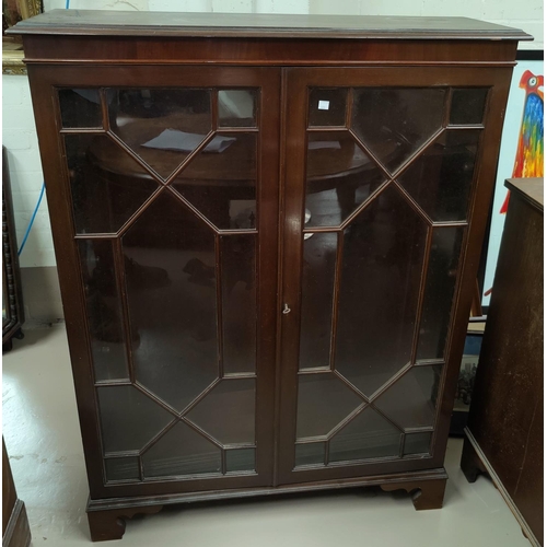 606 - A Georgian style mahogany display cabinet enclosed by 2 astragal glazed doors