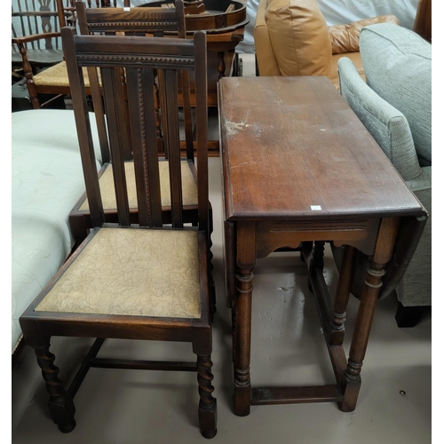 607 - A 1930's oak dining table with oval drop leaf top; a set of 4 barley twist dining chairs