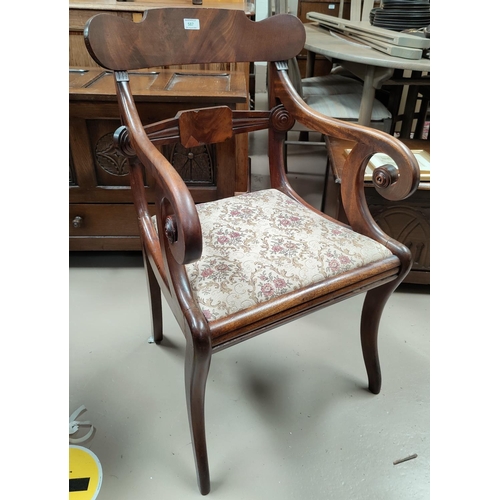 587 - A Regency figured mahogany carver chair with scroll arms, on sabre legs