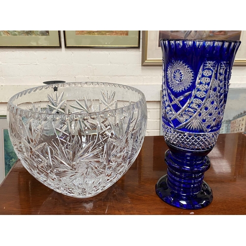 280a - A large heavy cut glass bowl and a blue overlaid large trumpet shaped vase