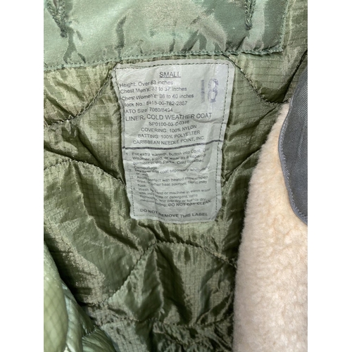 60E - A miltary Southern Athletic Co single breasted jacket dated 1957; a 1961 pilot's military jacket lin... 