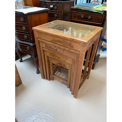 612b - A nest of 4 Chinese carved hardwood occasional tables.