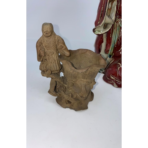 101 - A Chinese group of figures holding a large frog with glazed decoration and a stoneware figure of a m... 