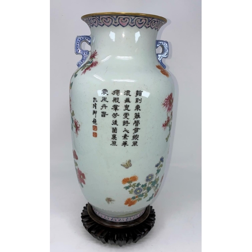104 - A Chinese vase decorated with detailed flowers and insects, flared rim and 2 handles with character ... 