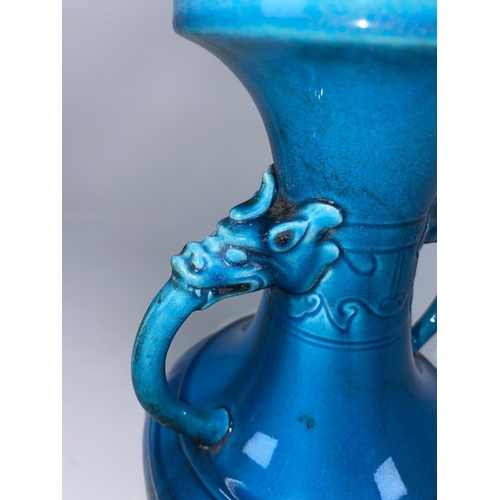 116 - A Chinese turquoise glazed vase with double handles  opening from the mouths of mythological creatur... 