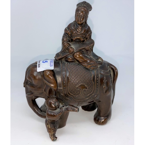 135 - A Chinese bronzed metal group - female deity on an elephant, height 13cm; a selection of African car... 