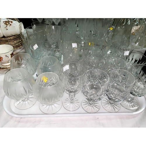 165 - A set of 12 crystal champagne flutes; other cut drinking glasses