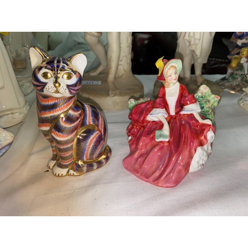 169 - A Meissen style group:  2 seated lovers; 2 Royal Doulton figures; a Royal Crown Derby cat; a Herend ... 