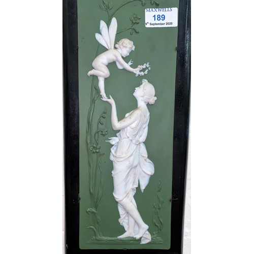 189 - A bisque wall plaque depicting a woman and fairy in white relief against a green ground, height 32.5... 