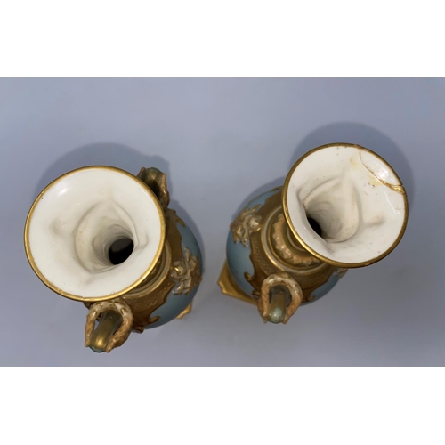 259 - A pair of Royal Worcester balluster vases with ornate gilt neck, facemask mounts decorated with cran... 
