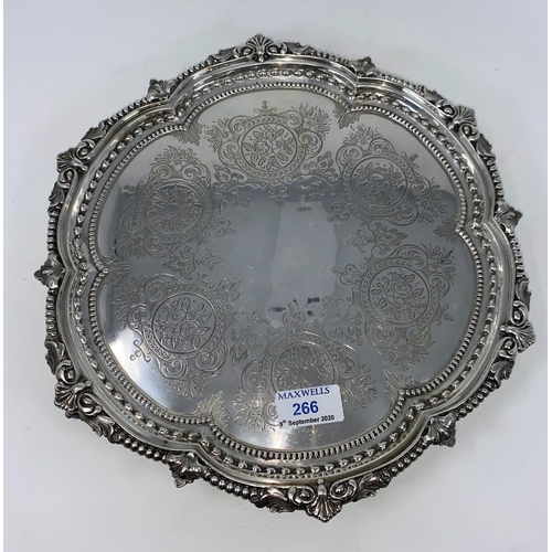 266 - A Victorian hallmarked silver circular scalloped salver with headed accanthus border with 3 ball and... 