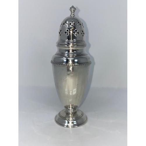 267 - A silver sugar dredger of ribbed tapering form with pierced domed top and circular foot, B1932 3.5oz
