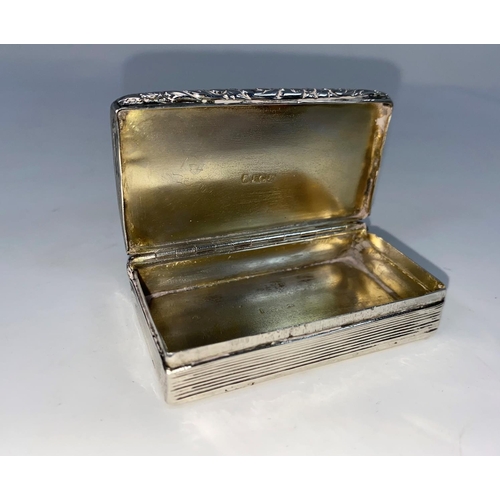 284 - A rectangular silver Georgian snuff box with engine turned ribbed decoration and embossed border (no... 