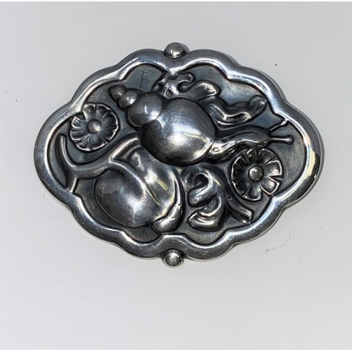 290 - A Georg Jensen Danish silver shaped oval brooch depicting a snail and flowers in relief, stamped Geo... 