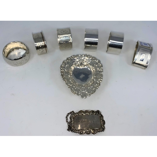 303 - Six various silver napkin rings; an embossed silver bon-bon dish; a silver 