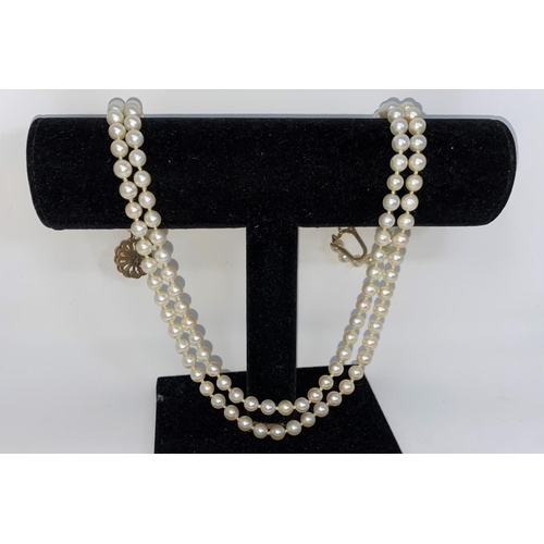 331 - A cultured pearl double strand necklace by Mikimoto, with 9 carat clasp set pearl and