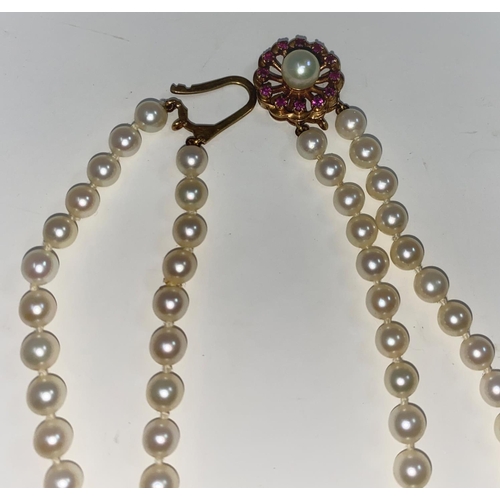 331 - A cultured pearl double strand necklace by Mikimoto, with 9 carat clasp set pearl and