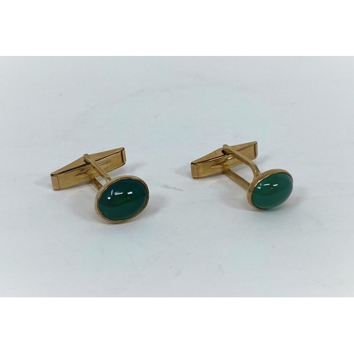 333 - A 9 carat hallmarked gold pair of cufflinks set green cabochon stones, 6.5 gm