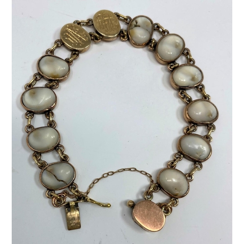 337 - A rose coloured metal bracelet with oval shell set links, stamped '9c', 17.7 gm gross