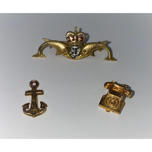 338 - A Submariner's lapel badge in 9 carat hallmarked gold and enamel; a 9 carat hallmarked telephone cha... 
