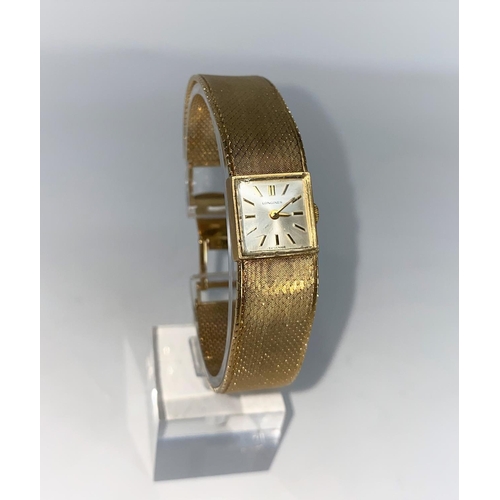 351 - A ladies 9 carat hallmarked gold wristwatch by Longines, with square dial, baton numerals and integr... 