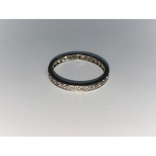 361 - A white metal diamond set eternity ring, unmarked, tests as 18 ct, 2 gm
