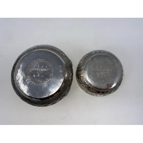 370 - Two Middle Eastern white metal bowls decorated in relief with elephants, snakes etc