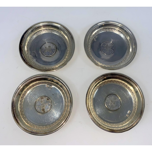 376 - A set of 4 Iranian small white metal dishes with inset coins, stamped '800'