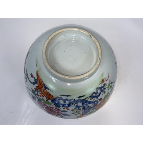 53 - An 18th century Chinese punch bowl with polychrome decoration of flowers, diameter 24cm (minor chipp... 