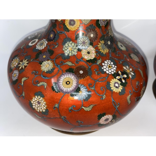 75 - A late 19th/early 20th century Japanese pair of cloisonné vases of compressed onion form with tall s... 