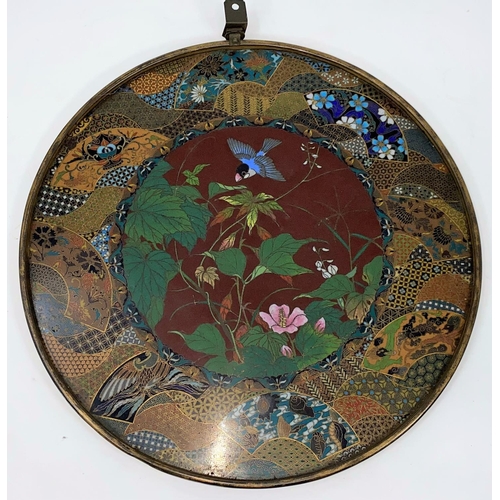 76 - A late 19th/early 20th century Japanese cloisonné circular wall plaque, the central panel with finel... 