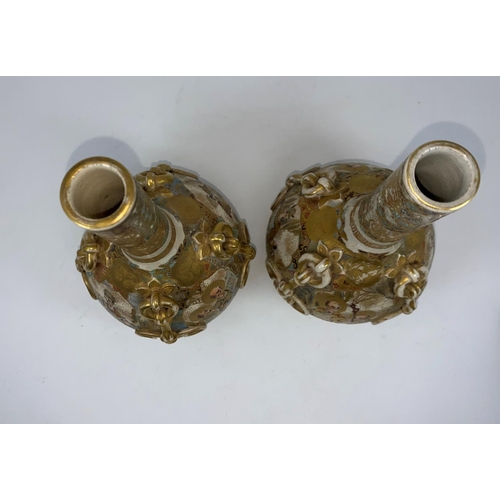77 - A pair of satsuma vases with ovoid bodies and slender necks, relief ropework decoration, the reserve... 