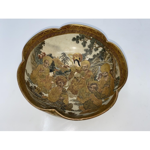 81 - A Satsuma circular lobed bowl decorated with immortals, character seal to base Satsuma and Hododa ci... 
