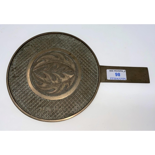86 - A Chinese bronze hand mirror, the back with central relief leaves against a trellis border, 4 charac... 