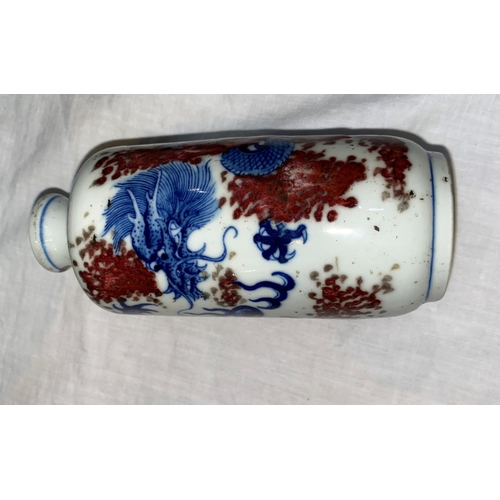 103 - A Chinese rouleau blue and white vase decorated with dragon and thick red glaze spattering, fish mar... 
