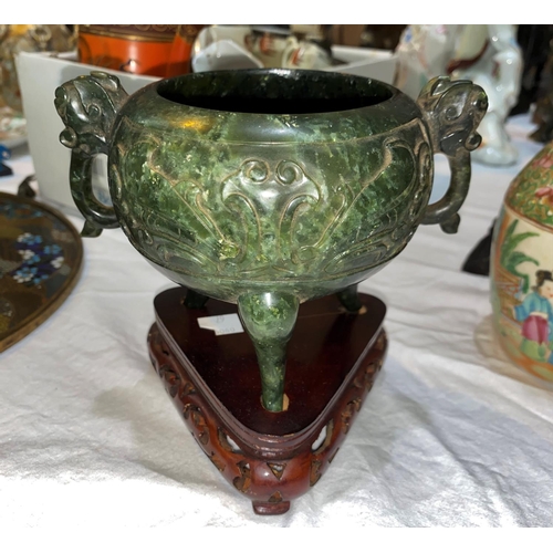 67 - A cauldron censor in spinach jade coloured soapstone, with elephant mask handles and relief decorati... 