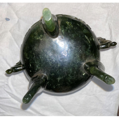67 - A cauldron censor in spinach jade coloured soapstone, with elephant mask handles and relief decorati... 
