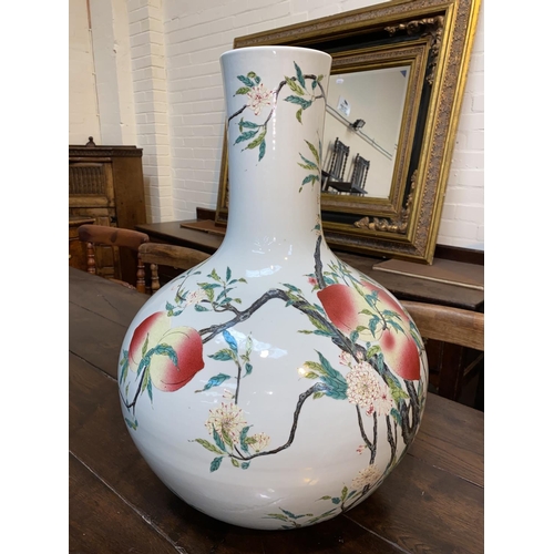 93 - A very large Chinese porcelain bottle vase decorated in polychrome with peaches on branches, with ch... 