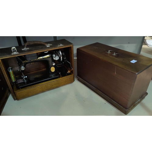 25 - A Singer hand operated sewing mache in leather effect case; a similar by Naumann in inlaid case