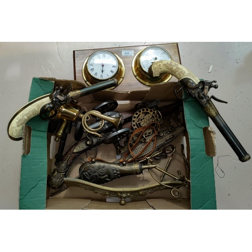 409 - A collection of reproduction pistols and guns; a reproduction ship's clock/barometer; brassware; etc... 