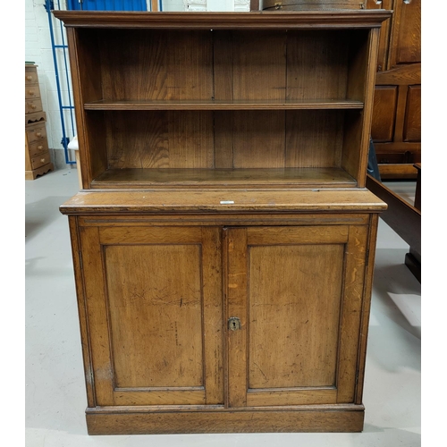 544 - A late 19th century oak chiffonier with double cupboard and open shelf over