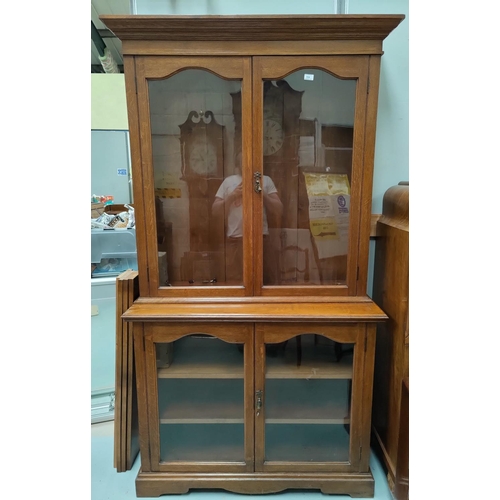 556 - A 1930's oak bookcase with double glazed cupboard above below, w 114 x h 210cm