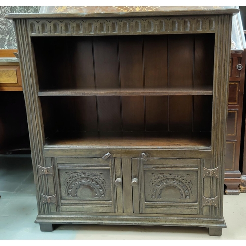 563 - A carved oak reproduction bookcase, 2 height with cabinet under