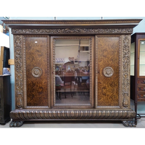 565 - A late 19th century Continental monumental side/display cabinet with extensive carved decoration, mo... 