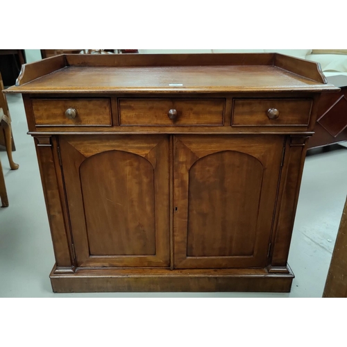 566 - A Victorian mahogany small side cabinet with raised gallery and 3 drawers over double arched panel c... 