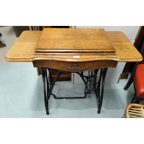 567 - A cast iron base and oak table for a Jones treadle sewing machine (no machine)