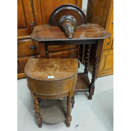 570 - A 1930's sewing table with box top; a 1930's 2 tier occasional table with canted edging, on barley t... 