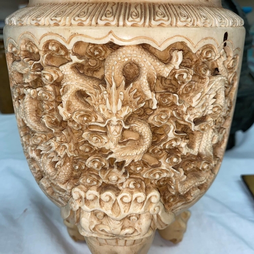 125 - An early 20th century ivory censer standing on 3 legs with main section depicting carved dragons, th... 